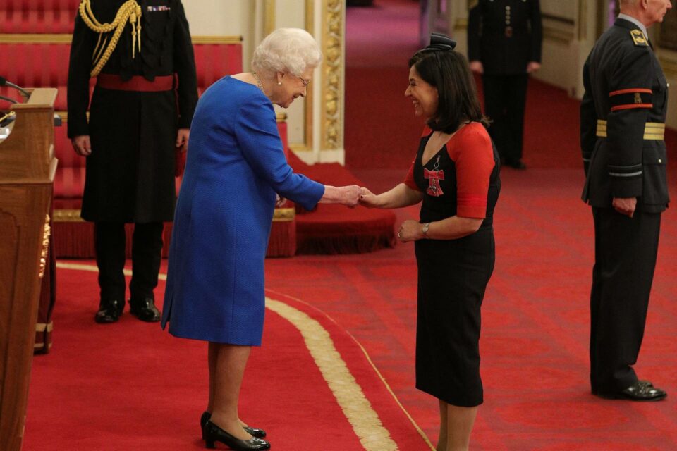 Janice Lopatkin shaking hands with Queen
