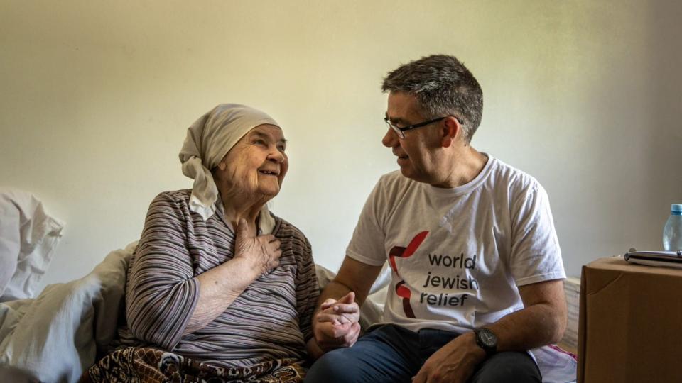 World Jewish Relief CEO Paul Anticoni with elderly woman in Eastern Europe