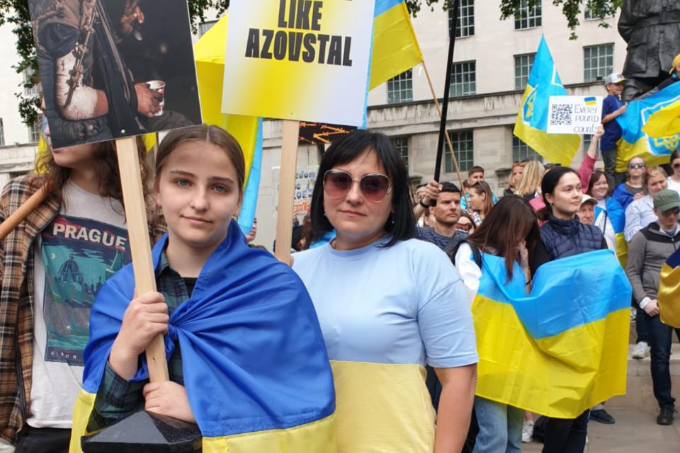 Woman standing in Ukrainian protest wearing yellow and blue