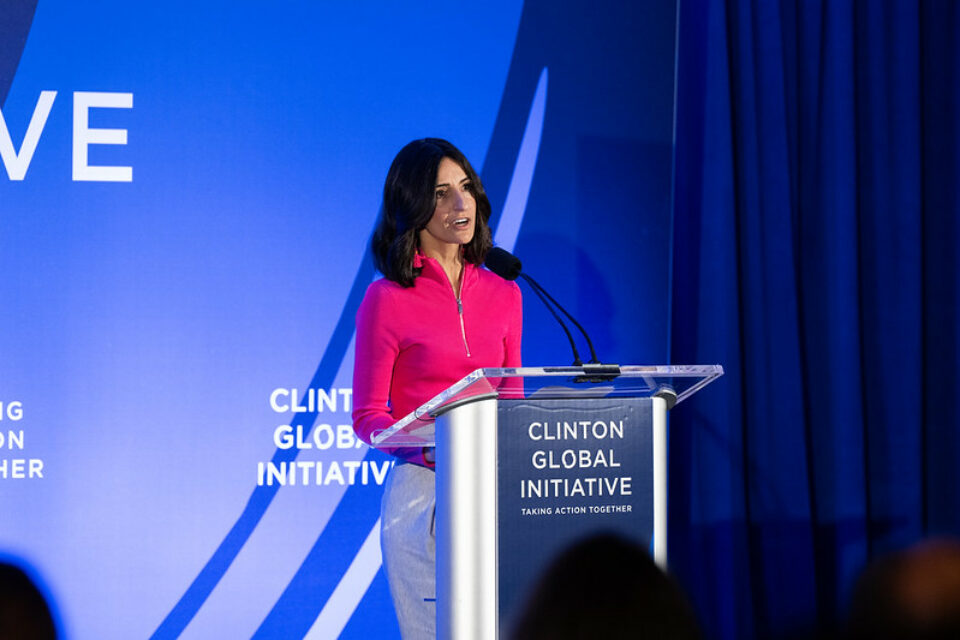 Rabbi Dina Brawer standing on podium at Clinton Global Initiative September Meeting